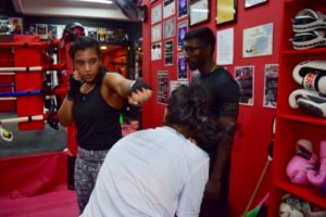 Teenage boxer learning how to effectively block attacks under expert supervision