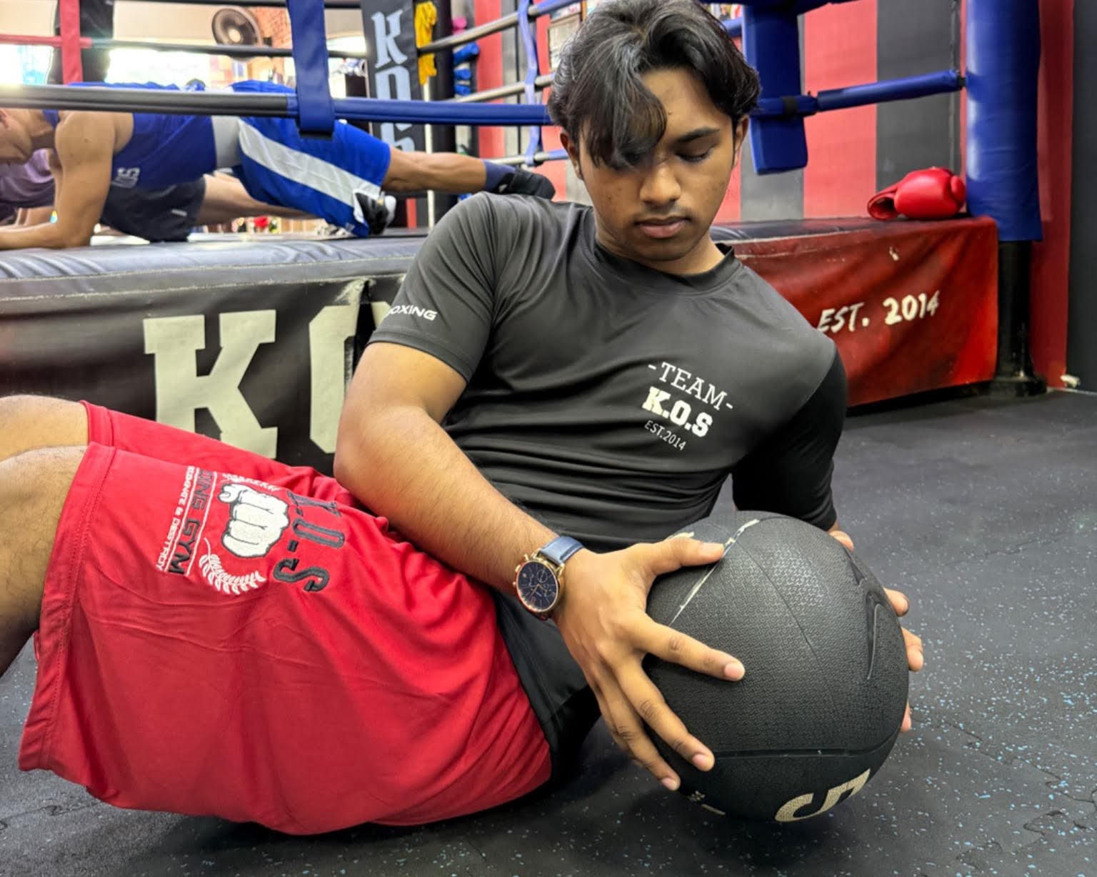boxer training with medicine ball in kos boxing gym