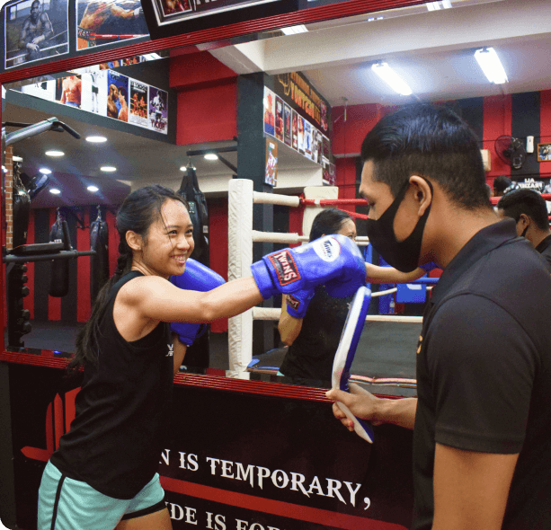 Female boxer training With Coach