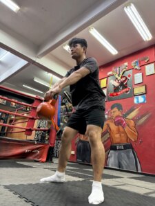 guy doing kettlebell swing training