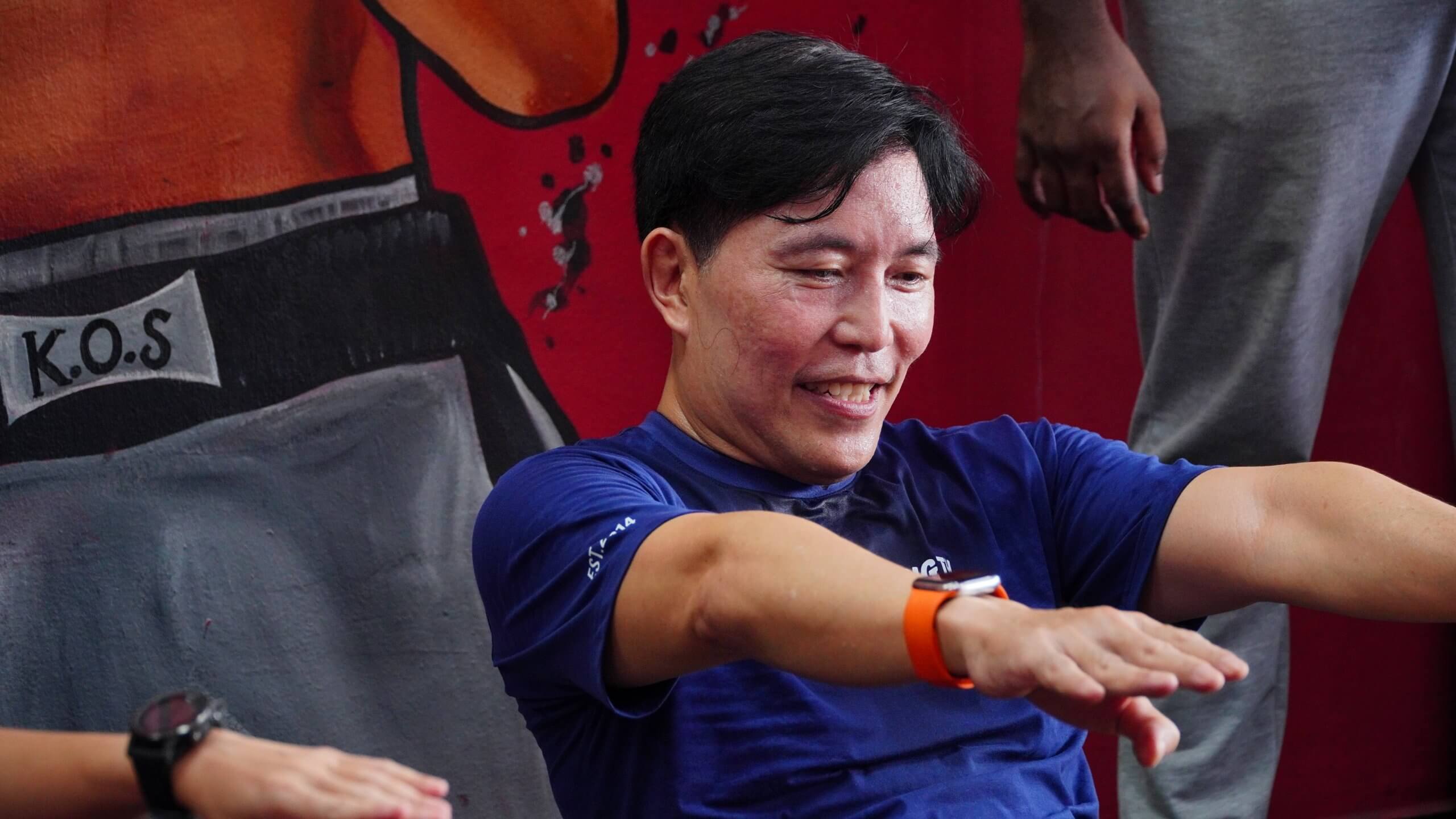 man smiling while performing sit ups at king of strength boxing gym